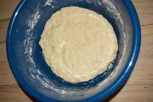 Kneaded fetal dough in a blue bowl. Photo the process of making the birth dough. Birth dough