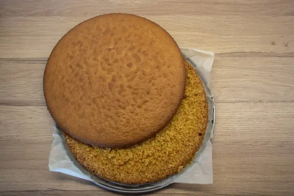 Biscuit round cake cut in half. Photo a biscuit cake. Biscuit cake cut into two flat parts
