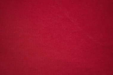 Kırmızı örgü arka plan. Örgü örülmüş kumaş kırmızıdır. Kırmızı arkaplan