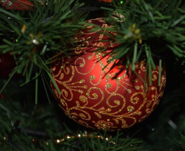 Yeni yıl ağacında altın madalyalı kırmızı top. Noel ağacı süslemek için bir oyuncak. Şenlikli dekorasyon