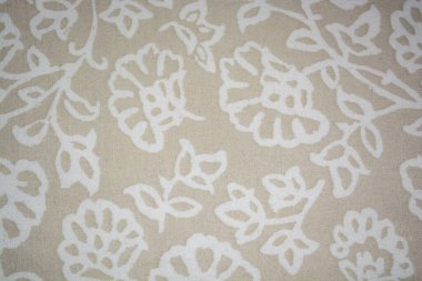 Kalıplı bej kumaş. Dokusu beyaz çiçeklerle örülmüş kumaş. Bej arka plan. Beyaz desenli bej kumaş
