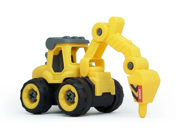 Seitenansicht Des Gelben Kunststoff Traktorbohrspielzeugs Isoliert Auf Weißem Hintergrund Schweres — Stockfoto