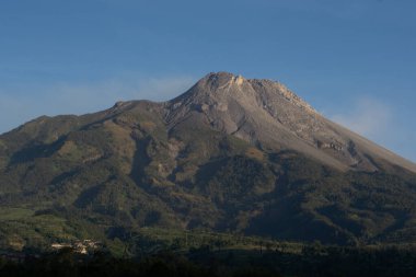 Arkaplanda açık mavi gökyüzü bulunan büyük Merapi Dağı, Selo Boyolali, Central Java - Endonezya.