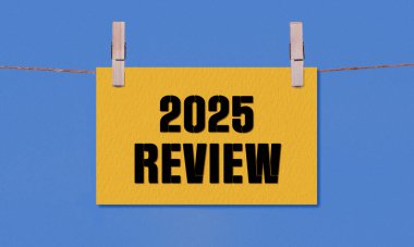 2025 REViEW Sembolü. Sözcükler 2025 Sarı Dikdörtgen Kağıt üzerinde Tahta Mandal Mavi Arkaplanda Asılı. İş 2025 Yeniden İzleme Uzayı Kopyalama Konsepti