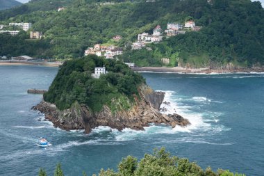 View of the island of Santa Clara from Monte Urgull in Donostia - San Sebastian. There is an abandoned lighhouse in the island, together with a small pier and a litle beach clipart