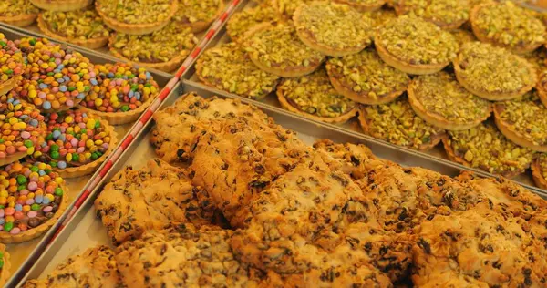 Close-up of local marketplace stall selling bakery and confectionary products.