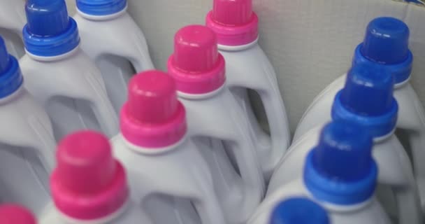 一排没有品牌的白色集装箱装家用化学品粉红色和蓝色帽子 纸盒里有多个装有液体把手的瓶子 高质量的4K镜头 — 图库视频影像