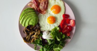 Pastırmalı yuvarlak tabak ve küçük parlak domatesler pürüzsüz modern masada duruyor. Mantarlar ve yumurtalar bağışıklığı güçlendirir besinleri gagayla zenginleştirir.