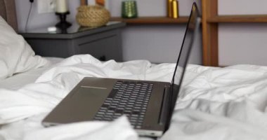 Modern apartman odasındaki dizüstü bilgisayar serbest çalışma kavramını ön plana çıkarıyor. Esnek program, iş ve rahat atmosferi birleştirmek için fırsat yaratıyor