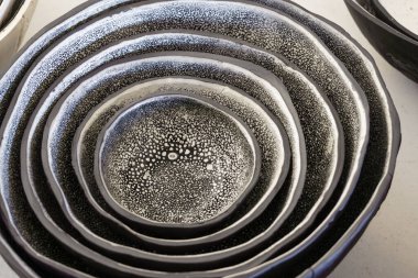 Siyah ve beyaz benekli el yapımı kil kaseler.