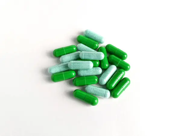 緑の丸薬の薬は健康シリマリウムのマリウムの肝臓の解毒のカプセルを治します ロイヤリティフリーのストック画像