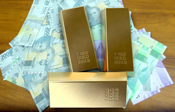 The 3D rendering image is a concept of a pile of gold bars on top of a pile of banknotes as a symbol of currency value