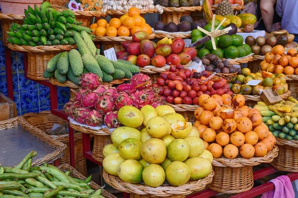 Fruit market, Machico, Madeira, Portugal, Europe. Exotic fruit in wicker baskets. Bananas, passion fruit, dragon fruit.