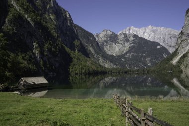 View of Obersee in Schnau am Knigssee. Reflection of the mountains in the water. Germany, Europe. clipart