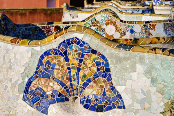 Detail of a colorful mosaic on a bench in Gell Park, Barcelona, Spain, Europe.