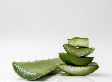 Aloe vera dilimlenmiş ve bir aloe vera yaprağı ile istiflenmiş..