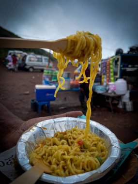 A closeup photo of a plate of a maggie against a blurred background clipart