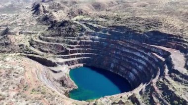 Mary Kathleen Uranyum Madeni 'nin hava görüntüsü. Mary Kathleen açık kesim uranyum madeni, 1956 ve 1963 yılları arasında ve 1975 ve 1982 yılları arasında tekrar çalıştı. Avustralya 'nın en eski madenlerinden biri olan milyonlarca ton uranyum cevheri üretti.. 