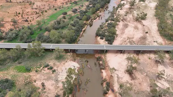 Stuart Karayolu Finke Nehri 'ni geçer ve Finke Nehri' nin nehir yatağının Alice Springs 'in 110 kilometre güneyindeki Kuzey Toprakları' ndaki Stuart Karayolu 'nun yakınındaki insansız hava aracı görüntülerini gösterir.
