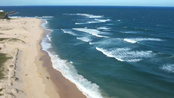 Newcastle Nobbys Beach NSW Australia Aerial View of Coastal Beach and Ocean Under Blue Sky and Rolling Waves