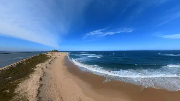 Newcastle Nobbys Beach NSW Australia Aerial View of Coastal Beach and Ocean Under Blue Sky and Rolling Waves