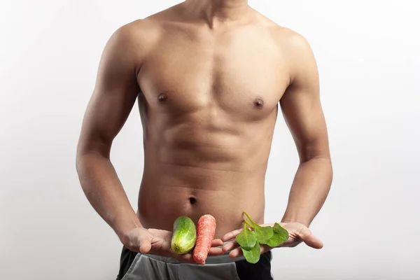 stock image athlete fitness person holding vegetables on his hand showing weight loss and healthy diet concept