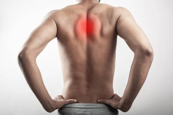 One shirtless male showing back with inflamed shoulder blades injury pain on scapula. The pain area is highlighted in red glow.