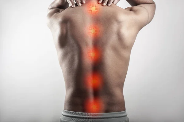 Мускулистый Человек Страдающий Травмы Позвоночника Боли Спине Выделены Красным Пятном Стоковое Изображение