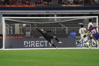 July 29, 2023, Arlington, Texas, United States: Real Madrid's goalkeeper Thibaut Courtois can't stop Barcelona's Fermin Lopez shot during the Soccer Champions Tour game between Barcelona and Real Madrid played at AT&T Stadium clipart