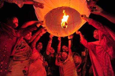 28 October 2023 Sylhet, Bangladesh: Buddhists religious followers are lighting fire lanterns to celebrate yearly Prabarana Purnima 2023 at the Buddhist temples in Sylhet, Bangladesh clipart