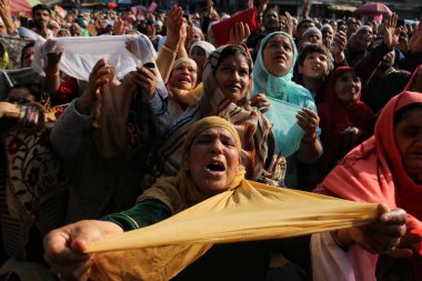 03.2023 Kasım 'ında Hindistan' ın Srinagar Kashmir kenti: Müslüman dindarlar, bir rahibin 'urs' veya yaklaşık 1000 yıl önce Bağdat 'ta yaşamış olan Sufi azizinin ölüm yıldönümünü simgeleyen bir kutsal emaneti sergilemesi için dua ediyorlar.