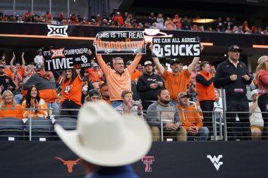 December 2, 2023, Arlington, Texas, United States: Texas Longhorns fans  hold banners during the 2023 Dr Pepper Big 12 Championship game between Texas Longhorns  and Oklahoma State Cowboys clipart