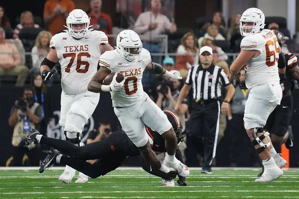 stock image December 2, 2023, Arlington, Texas, United States: Texas Longhorns   tight end Ja'Tavion Sanders is tripped by a Oklahoma State player during the 2023 Dr Pepper Big 12 Championship game between Texas Longhorns