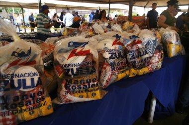18 Aralık 2023, San Francisco, Venezuela: Venezuelalılar, temel sepetten 300 ton yiyecek satarak binlerce aileye fayda sağlamak amacıyla bu pazartesi Halk Pazarı yardım programı sırasında yiyecek almak için sıraya girdiler.