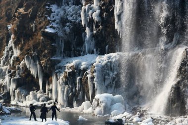 21 Aralık 2023, Srinagar Kashmir, Hindistan: Ziyaretçiler Srinagar 'ın kuzeyindeki Drung bölgesindeki donmuş şelaleye bakıyorlar. En sert 40 günlük kış dönemi olan Chillai-Kalan, Perşembe günü Kaşmir 'de başlıyor.