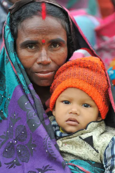 17 Ocak 2024 Sylhet-Bangladeş: Soğuk bir sabah Tarapur Çay Bahçesi 'nde gardiyanın kucağında bir çocuk. Sylhet 'te kış mevsiminin şiddetinin artması nedeniyle çocuklar ve yaşlılar acı çekiyor.