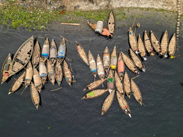 stock image January 30, 2024, Dhaka, Bangladesh: Aerial view of wooden passenger boats along the Buriganga River port. The boats, adorn with colourful patterned rugs, transport workers from the outskirts of the city to their job