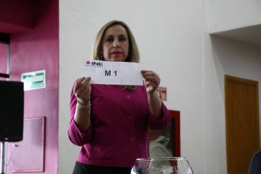 March 22, 2024, Mexico City, Mexico: A hostess  shows the role of the electoral raffle during  the Public Session of the Table of Representatives of the Presidential Debates clipart