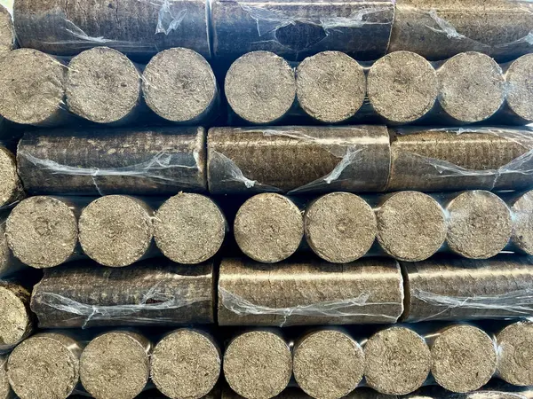 Wood briquettes for heating, packed in plastic film. High quality photo