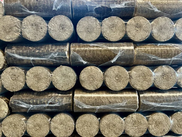 Wood briquettes for heating, packed in plastic film. High quality photo