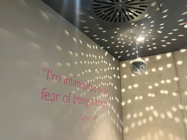 Shiny disco balls on a grey background. Beautiful Restroom with a quote on the wall. High quality photo