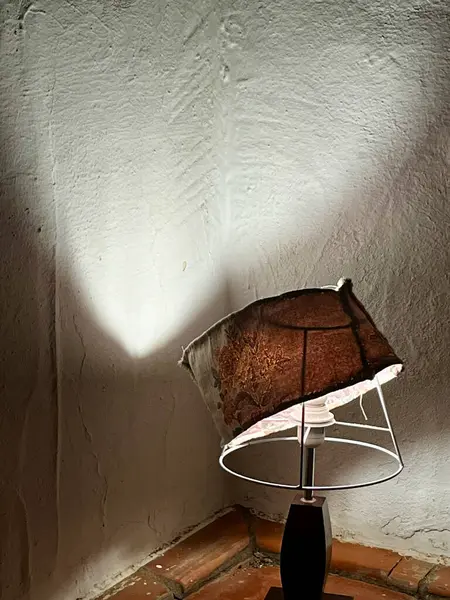 An old broken lamp with a shade on the tiled floor on balcon. High quality photo