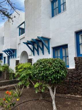 White house on the Canary Islands with blue windows. Vacation accommodation in Costa Adeje. High quality photo clipart