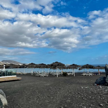 Morning in Playa La Caleta, Tenerife, Spain. Black sand, sun loungers and beach umbrellas. High quality photo clipart