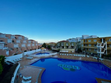 Costa Adeje, İspanya - 06.05.2024: Otel avlusu. Yüzme havuzu dairelerle çevrilidir. Yüksek kalite fotoğraf