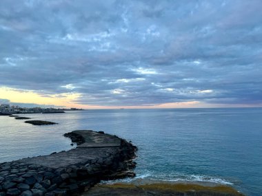 Beach of Fanabe in Costa Adeje town. Tenerife, Canary Islands, Spain. Early morning. Ocean barriers. High quality photo clipart