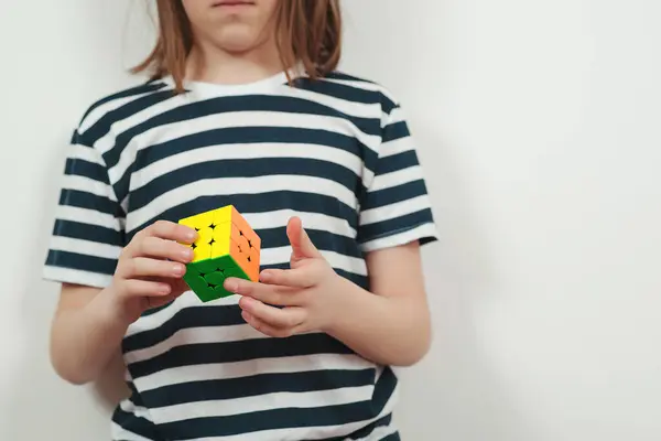 stock image Uzghorod, Ukraine - April, 04, 2023: Teenage boy playing with the Rubik's cube. Rubik's cube in child's hands.