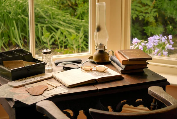 desk with books and glasses by the windows in vintage style