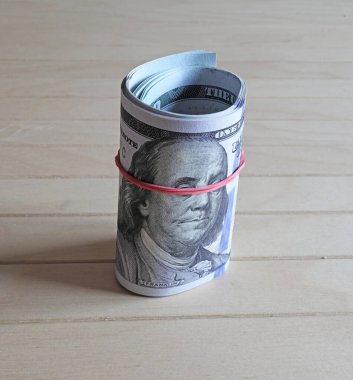 Tahta arka planda 100 dolarlık banknotlar. Yakın plan. Bir yığın 100 dolarlık banknot.