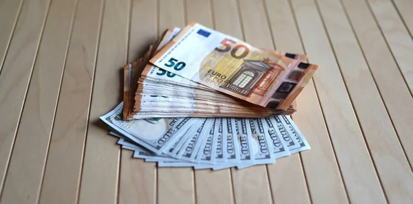 Bundle of Euro and dollars banknotes. 50 Euro and 100 Dollar banknotes.
